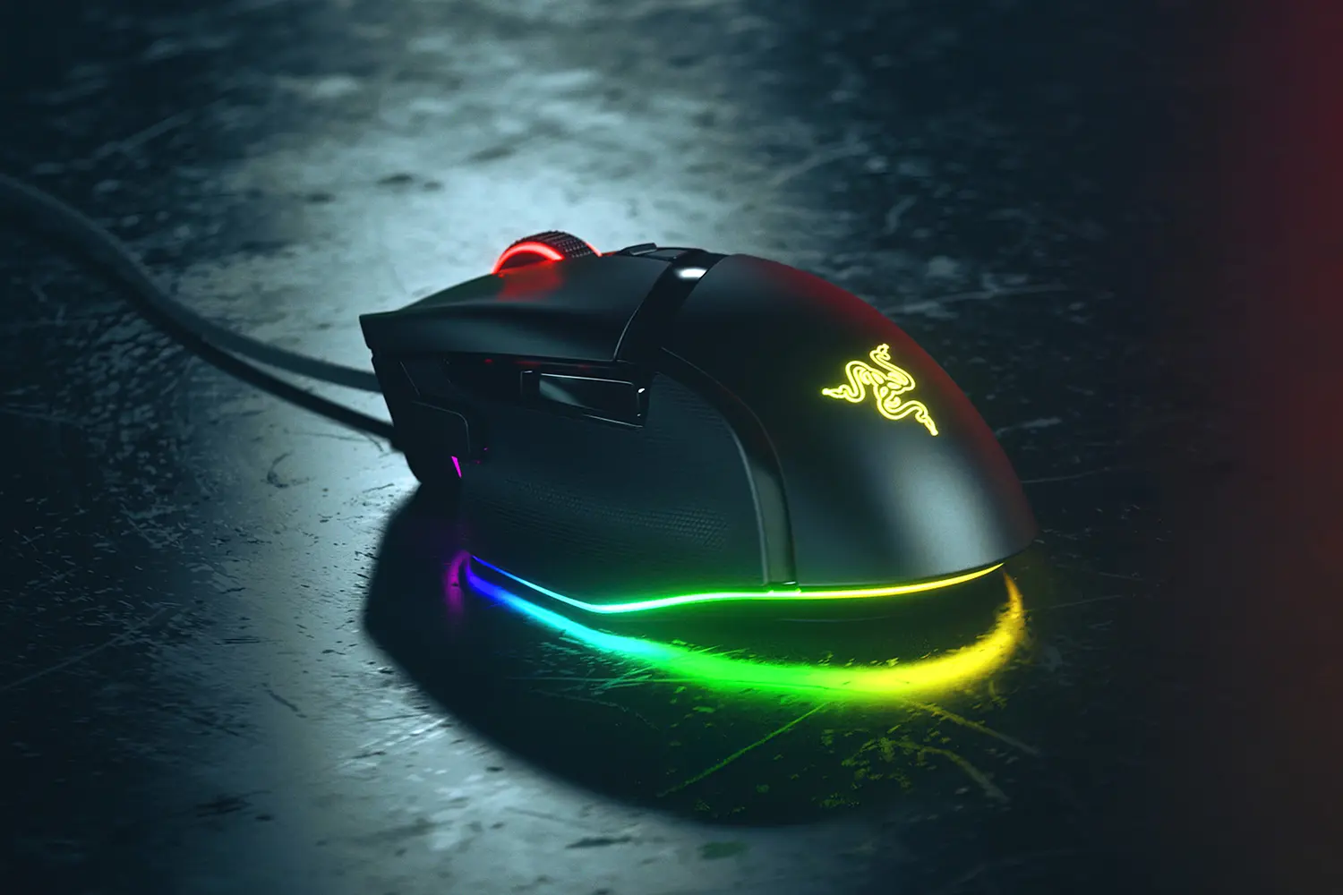 Razer Basilisk V3 wired mouse in black, rear three-quarter view showing the thumb rest, left side buttons, lit Razer logo and RGB underglow strip