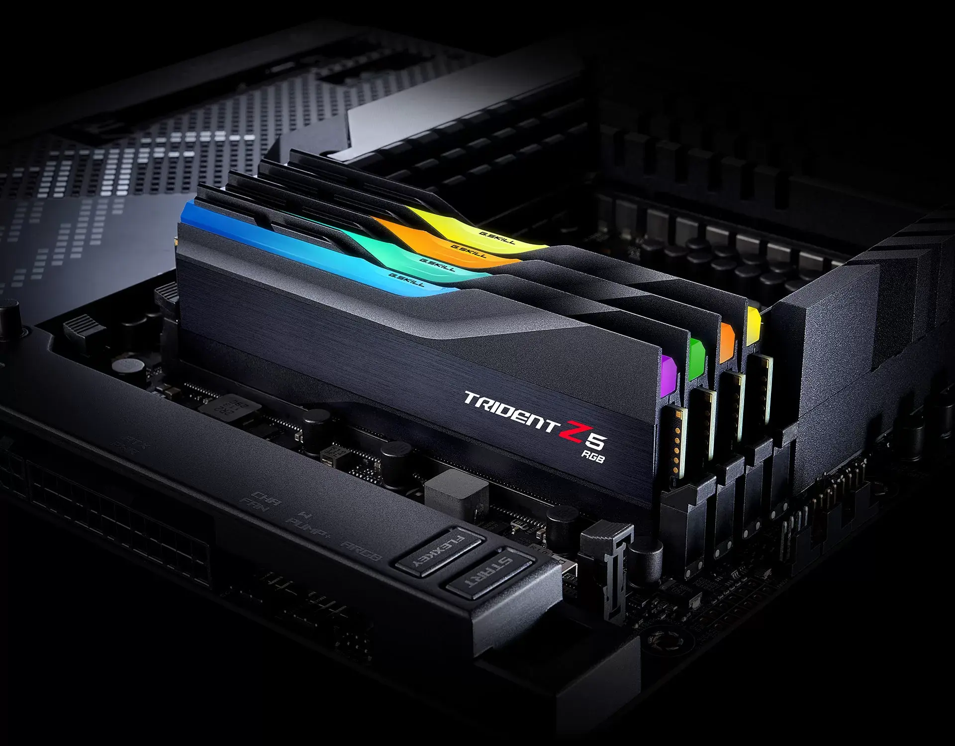 Four matte black G.SKILL Trident Z5 RGB DDR5 modules with lit light bars installed on a motherboard