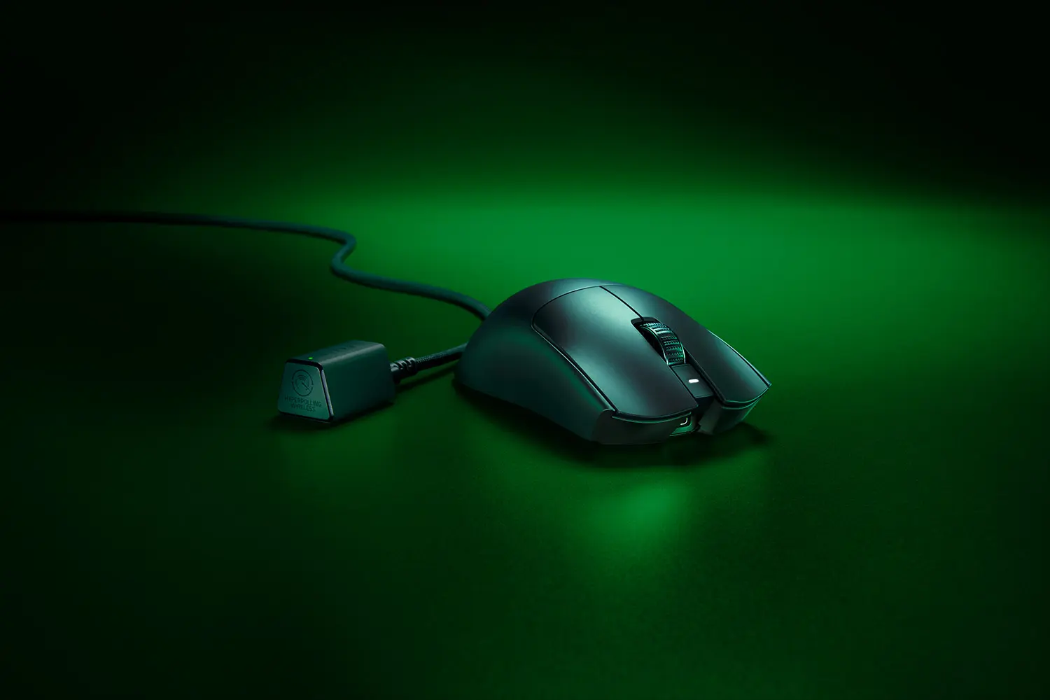 Razer Viper V3 Pro wireless mouse in black, front three-quarter view beside its HyperPolling Wireless Dongle and cable on a green-lit surface