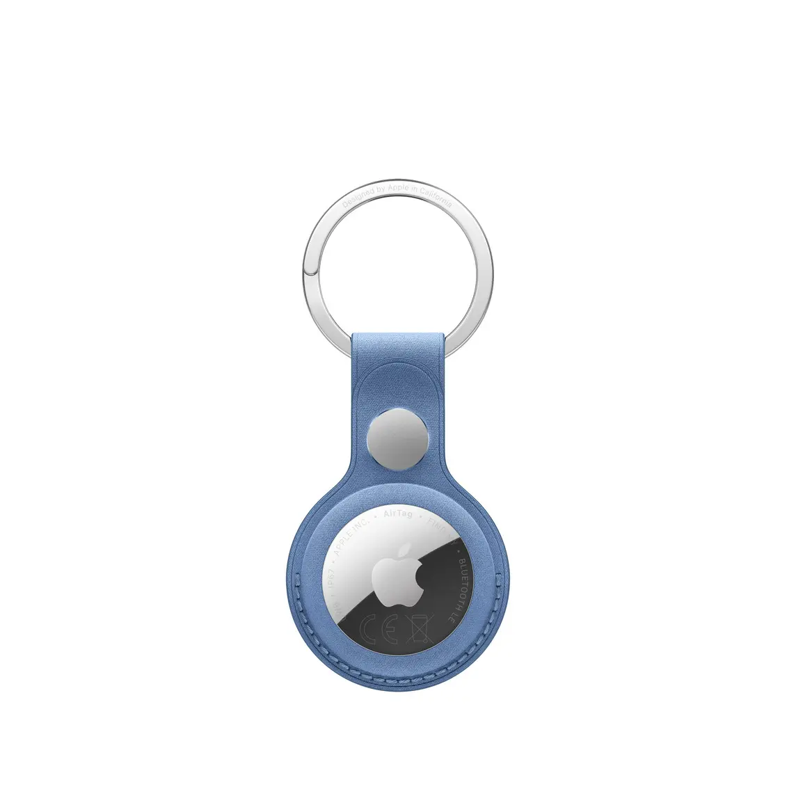 AirTag FineWoven Key Ring, snap closure button, stainless steel key ring, wildflower blue colour (greyish-blue) material covers the outer edge of AirTag, circular cutout, AirTag visible, Apple logo centred