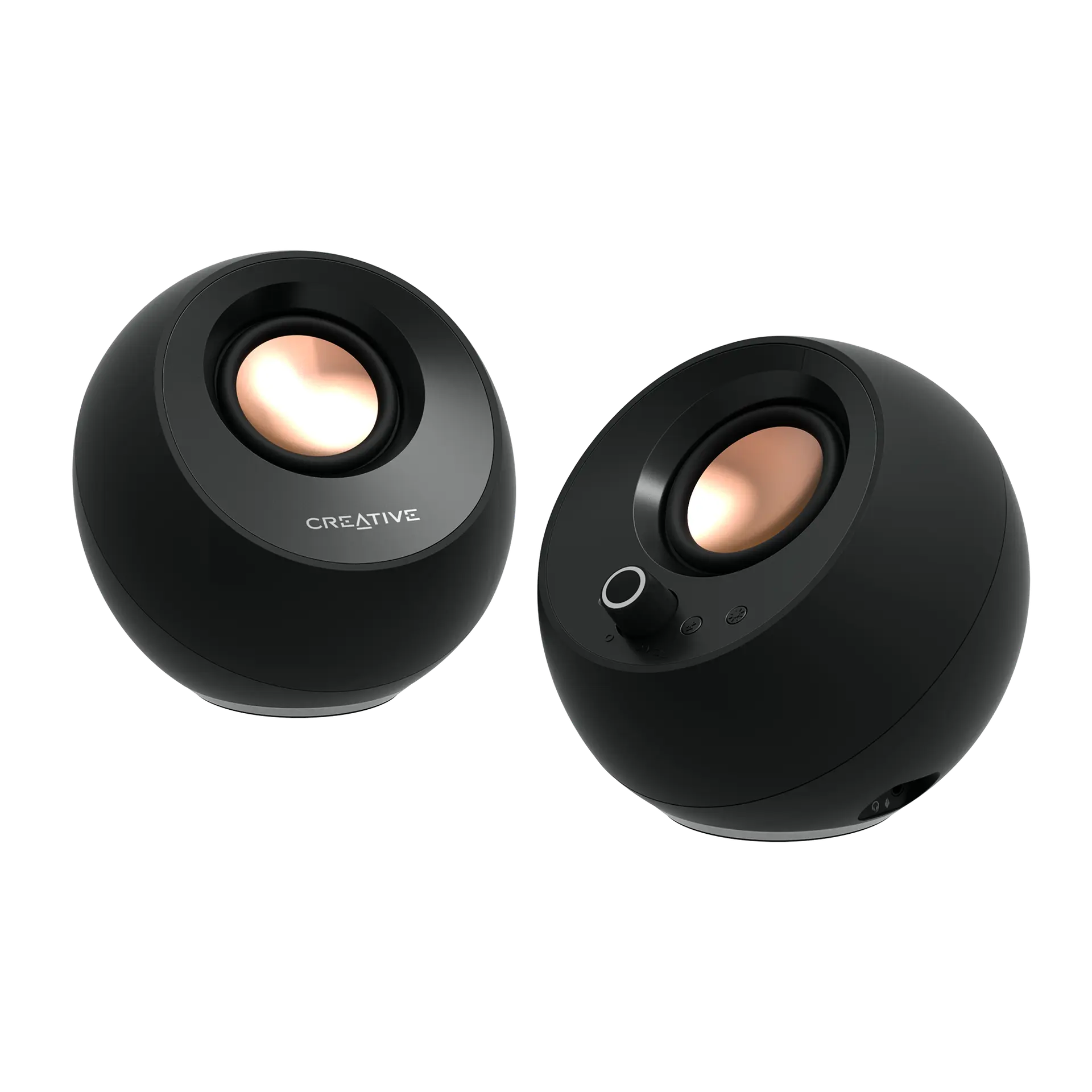 Creative Pebble Pro speakers in black: two round desktop speakers with copper-coloured drivers, the right one with a volume knob and rear ports
